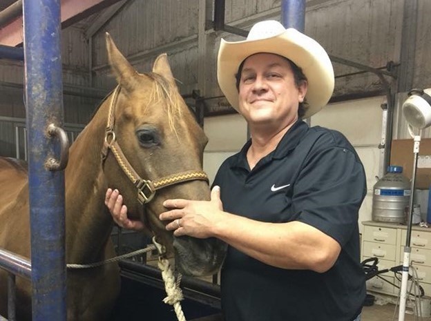 A person in a cowboy hat petting a horse, Pet Dental Care